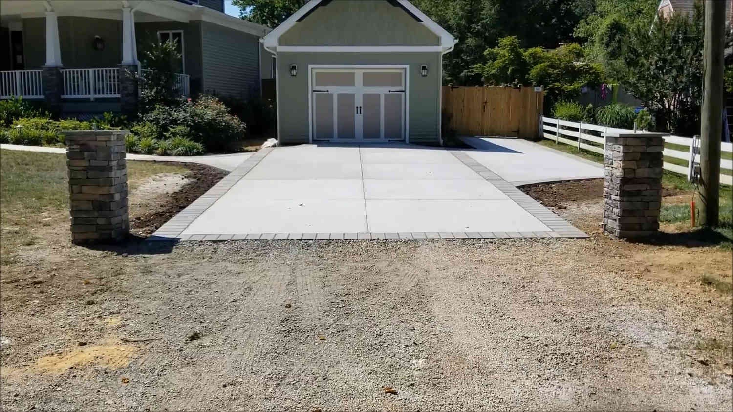 New concrete driveway leading up to a single car garage in Oakland, CA.