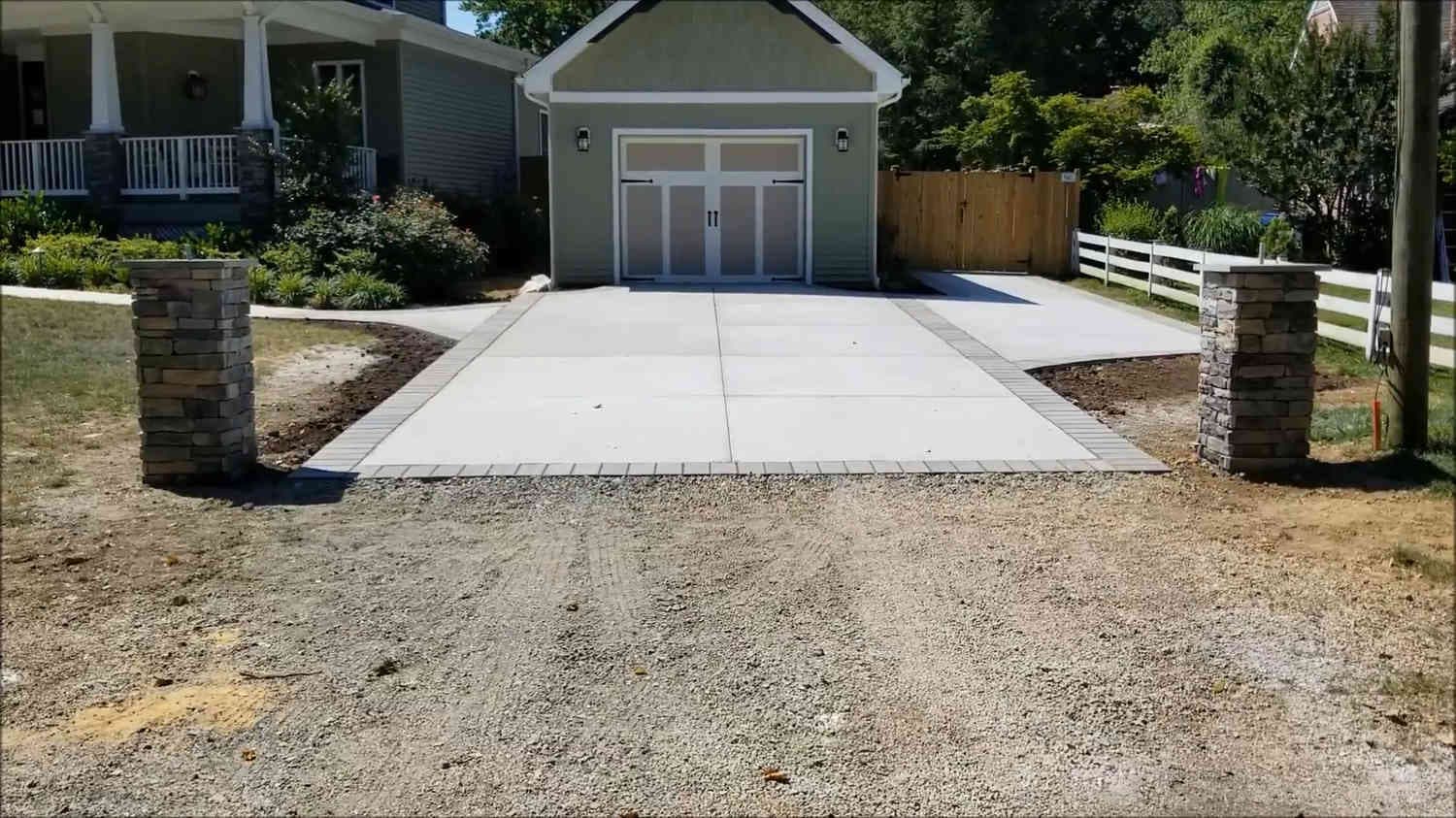 New concrete driveway leading up to a single car garage in Oakland, CA.