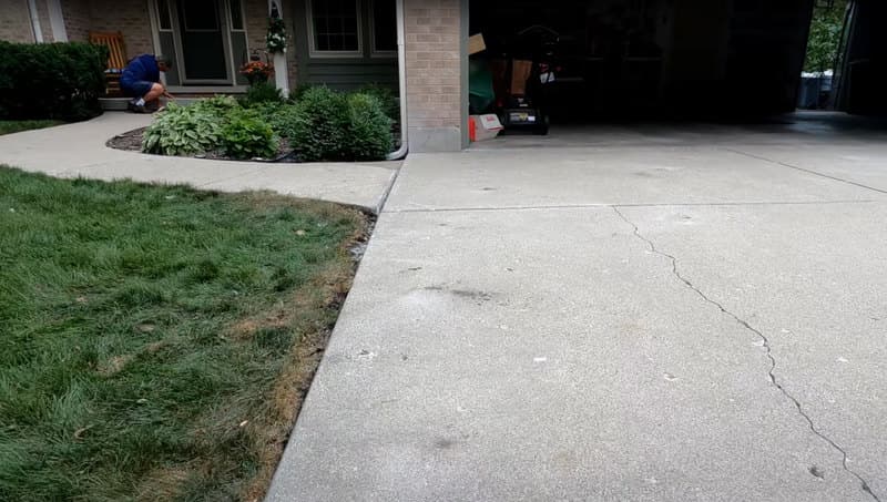 Leveling concrete walkway leading from garage to front door of house.