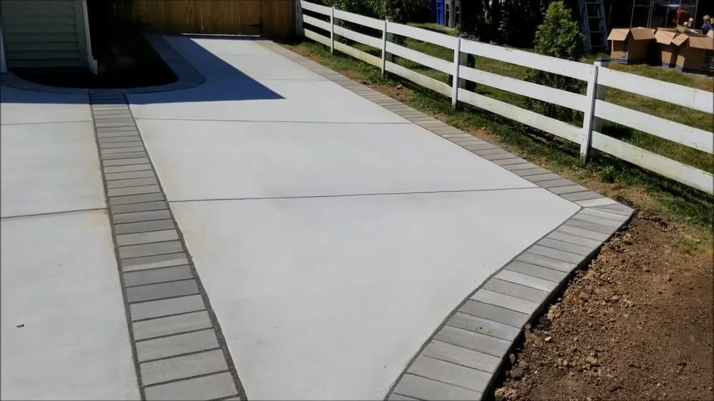 New concrete leading from driveway to the side of house.