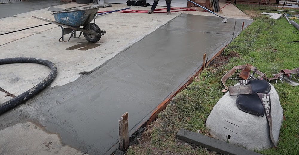 New, wet concrete for driveway extension.