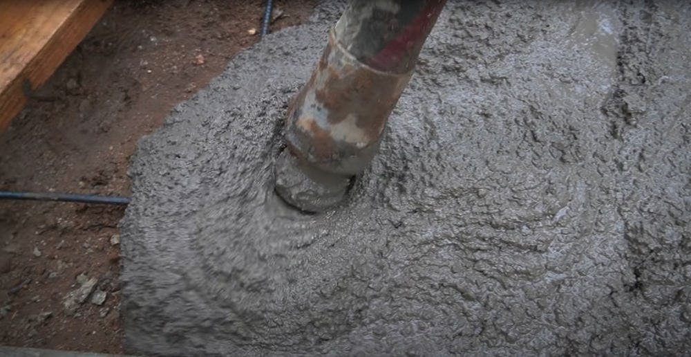 Pouring new concrete for concrete installation.